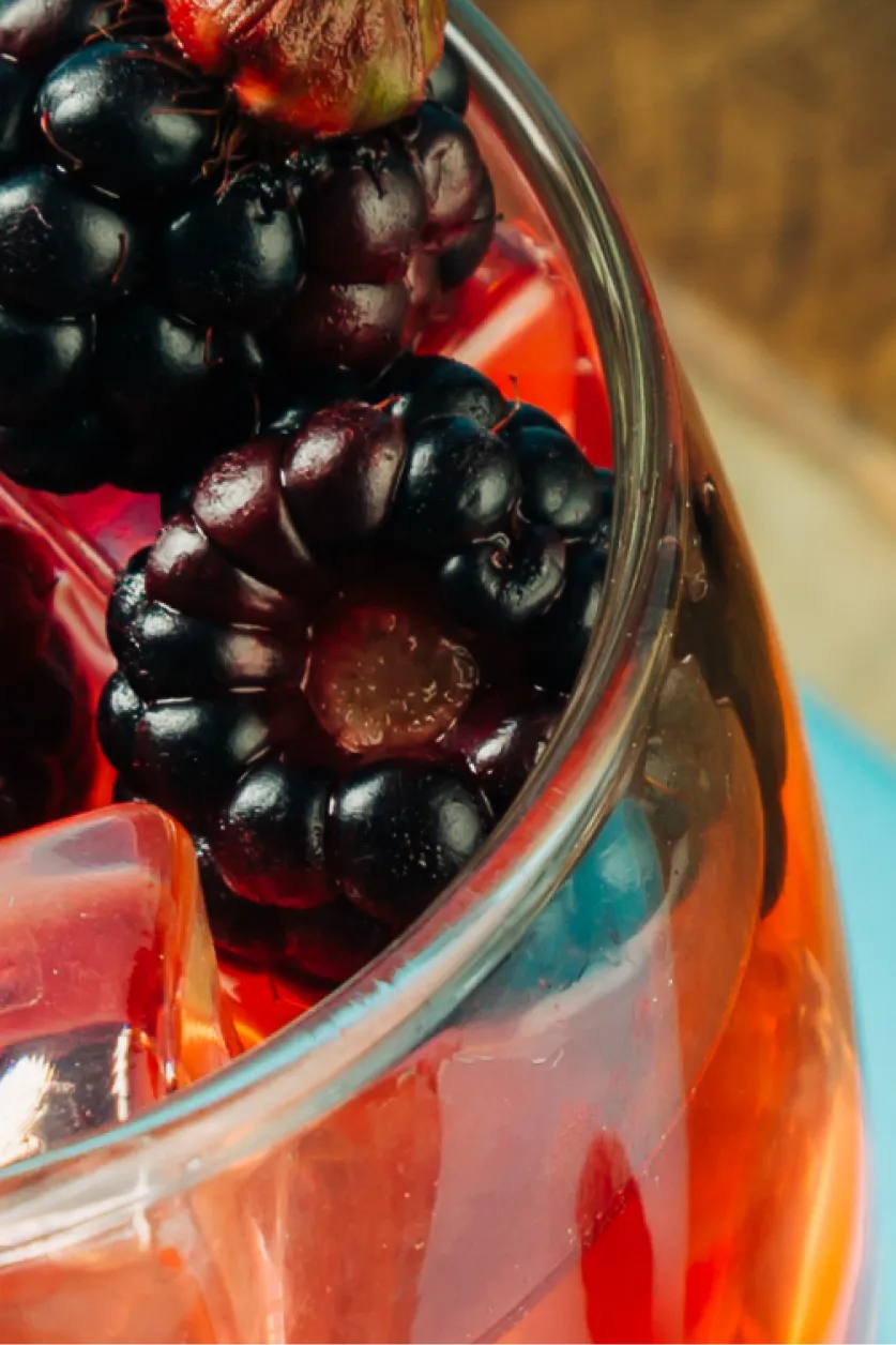 Close-up of a non-alcoholic berry basil bash with berries and ice