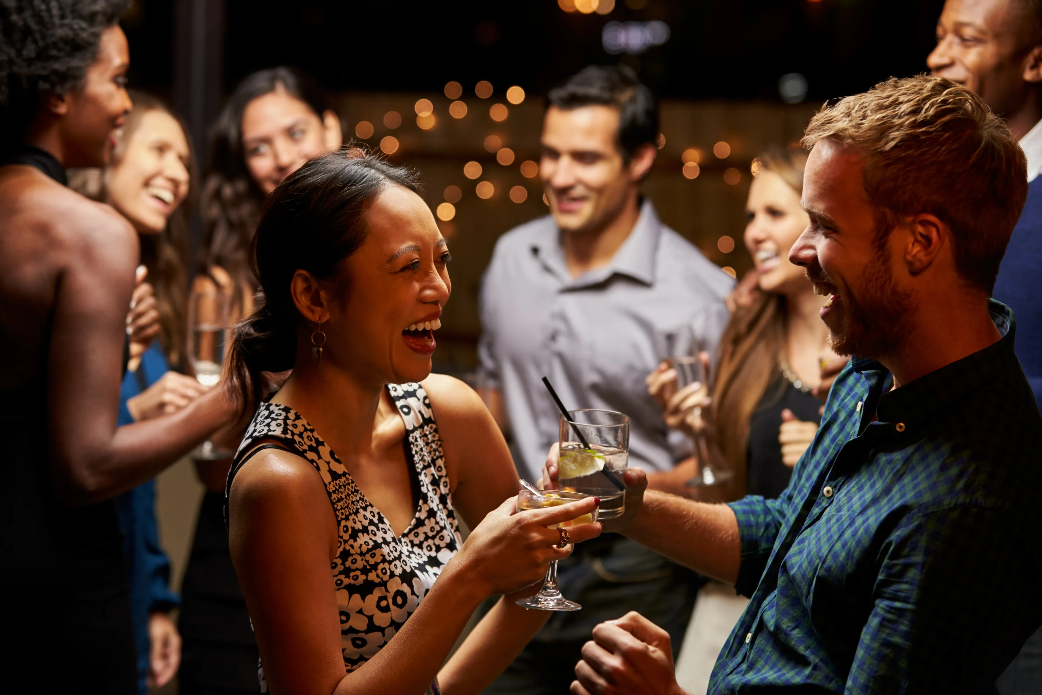 Young man and woman enjoying drinking alcoholic beverage together.