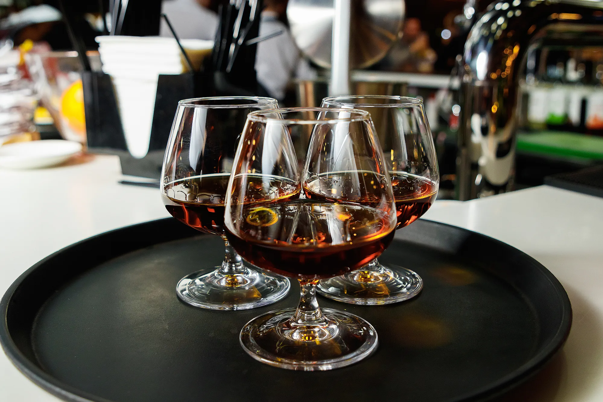 three-glasses-cognac-on-dark-tray