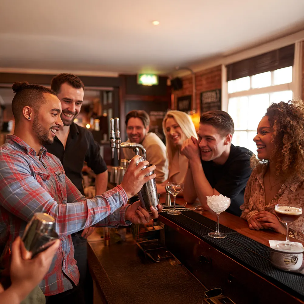 Bartender Demonstrating Cocktail Shaker Laughing Group Bar Counter Drinksmart